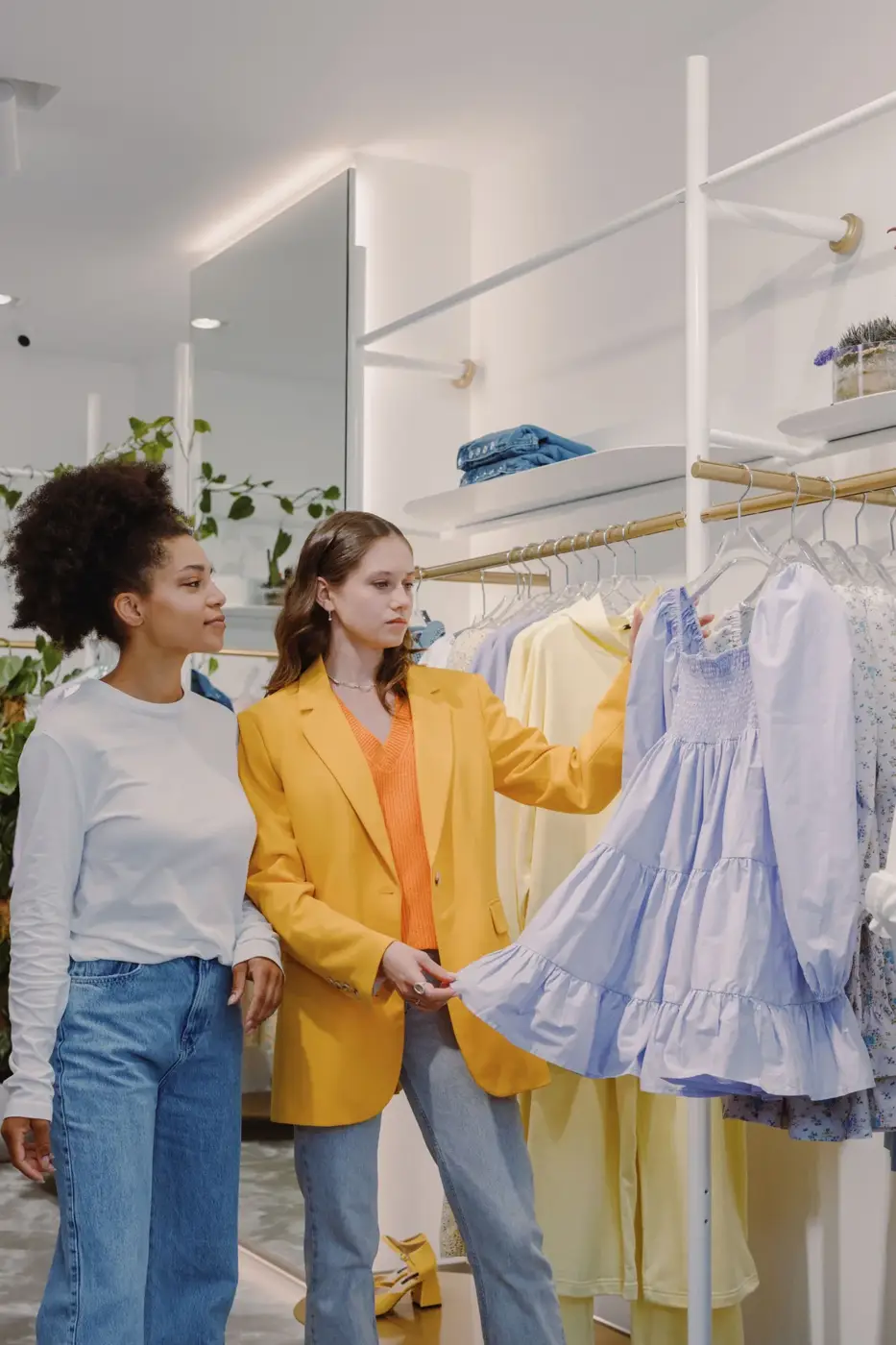 Editorial scene: choosing dresses in a boutique